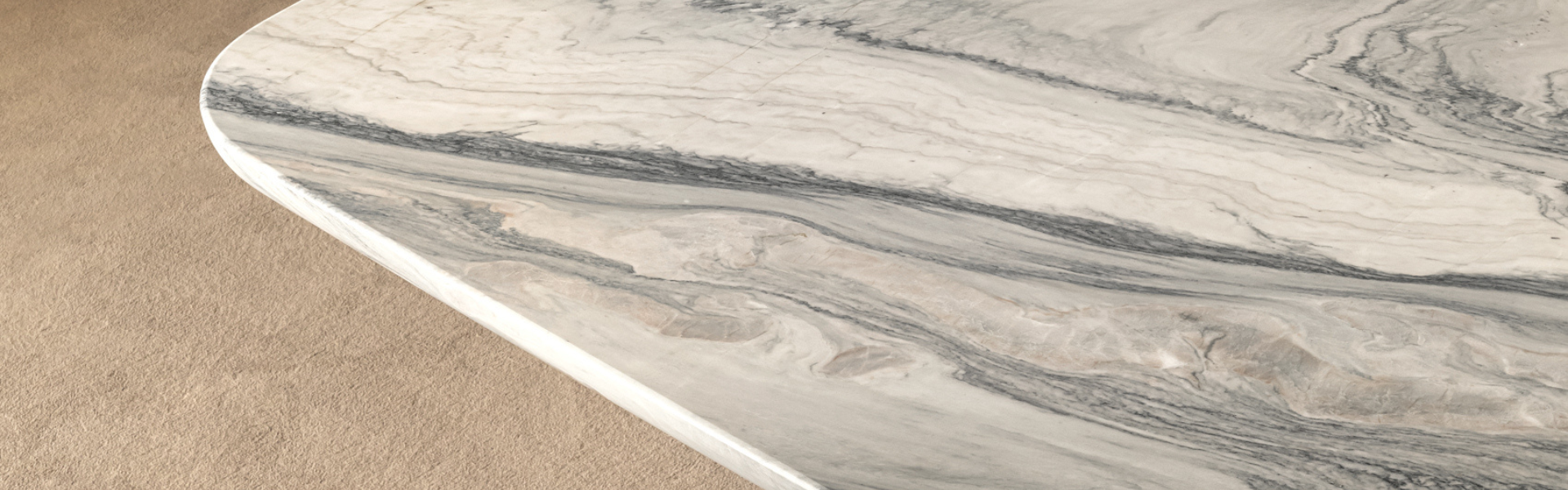 Close-up of beautiful white marble table edge on tan rug.