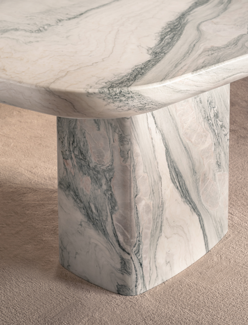 Close up white marble table with gray veining on rug