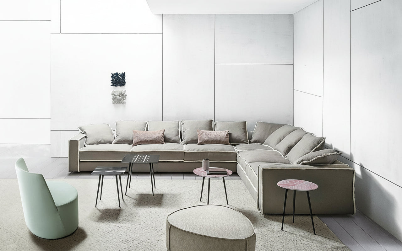 Modern living room featuring a large sectional sofa, accent chair, and stylish side tables.
