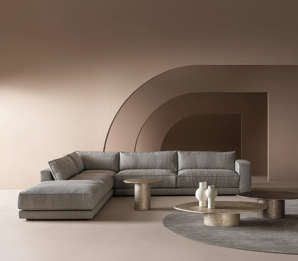 Modern living room featuring a gray sectional sofa, round metal coffee tables.