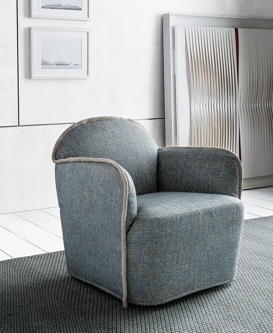 Modern blue-grey Casamilano Ada armchair with rounded back & textured fabric adds stylish, comfortable seating to contemporary living rooms