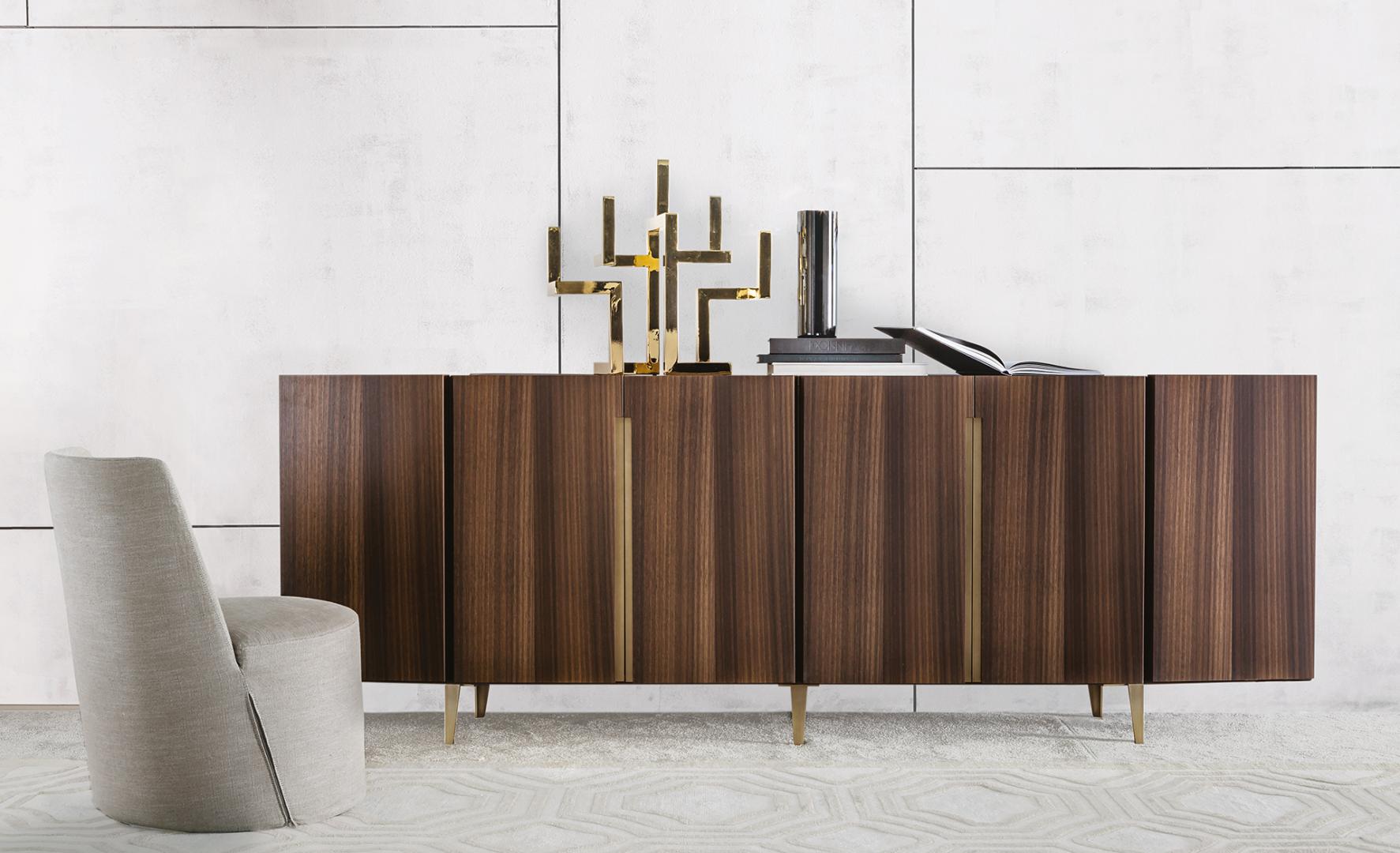 Interior view of a modern living space featuring a Casamilano Lea chair, wooden sideboard with gold accents, and stylish home decor