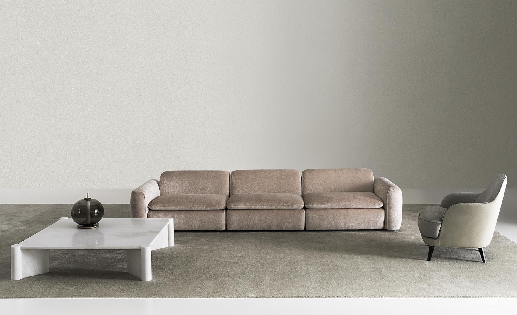 Interior with sofa, marble table, and Casamilano Liz chair creates a modern living space.