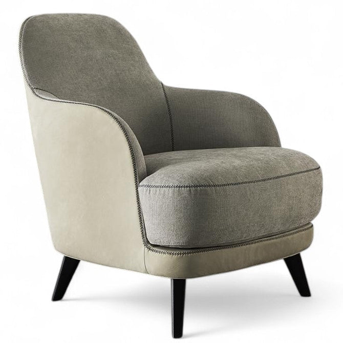 Studio shot of two-tone upholstered armchair with black legs on white background, modern accent chair.