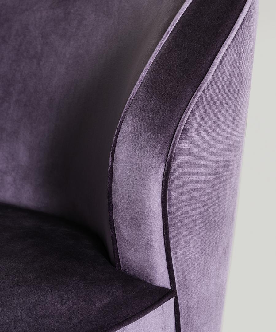 Close-up of the Dhora armchair by Casamilano, upholstered in luxurious purple velvet, highlighting its texture and design details
