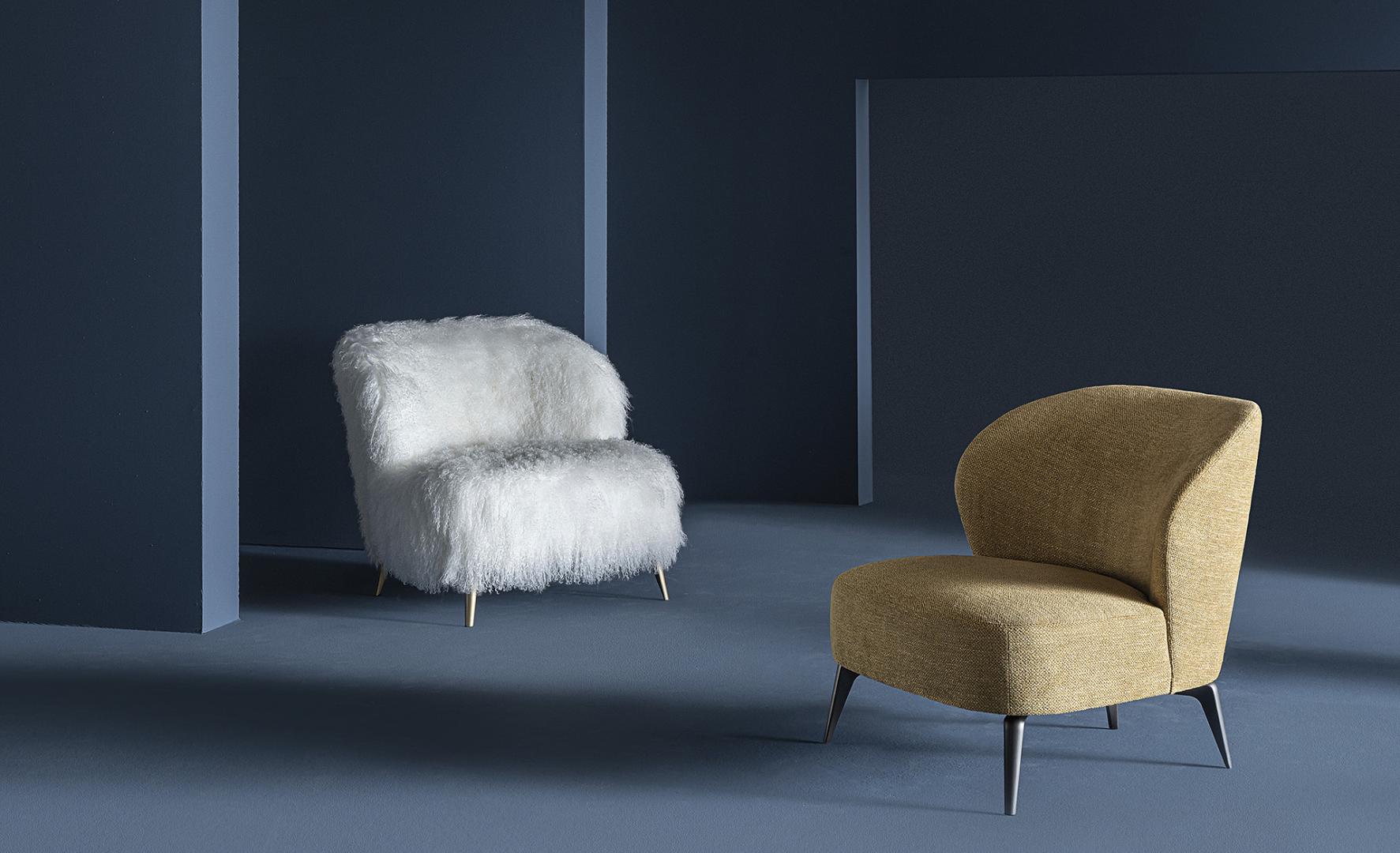 Interior with Casamilano Dhora Slim armchairs: a white faux fur chair with gold legs and a golden-brown textured chair with dark legs