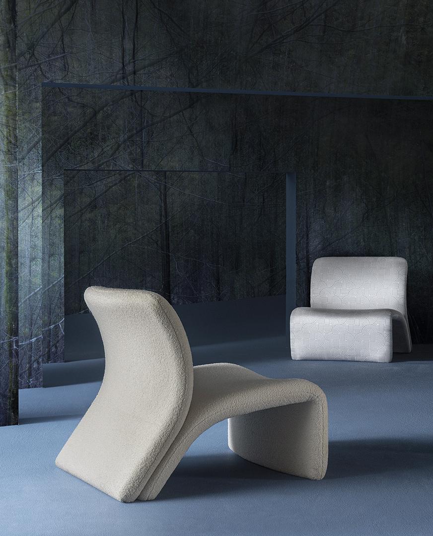 Interior with modern Casamilano armchairs against a dark forest scene, blending luxury furniture with minimalist design for elegant home decor
