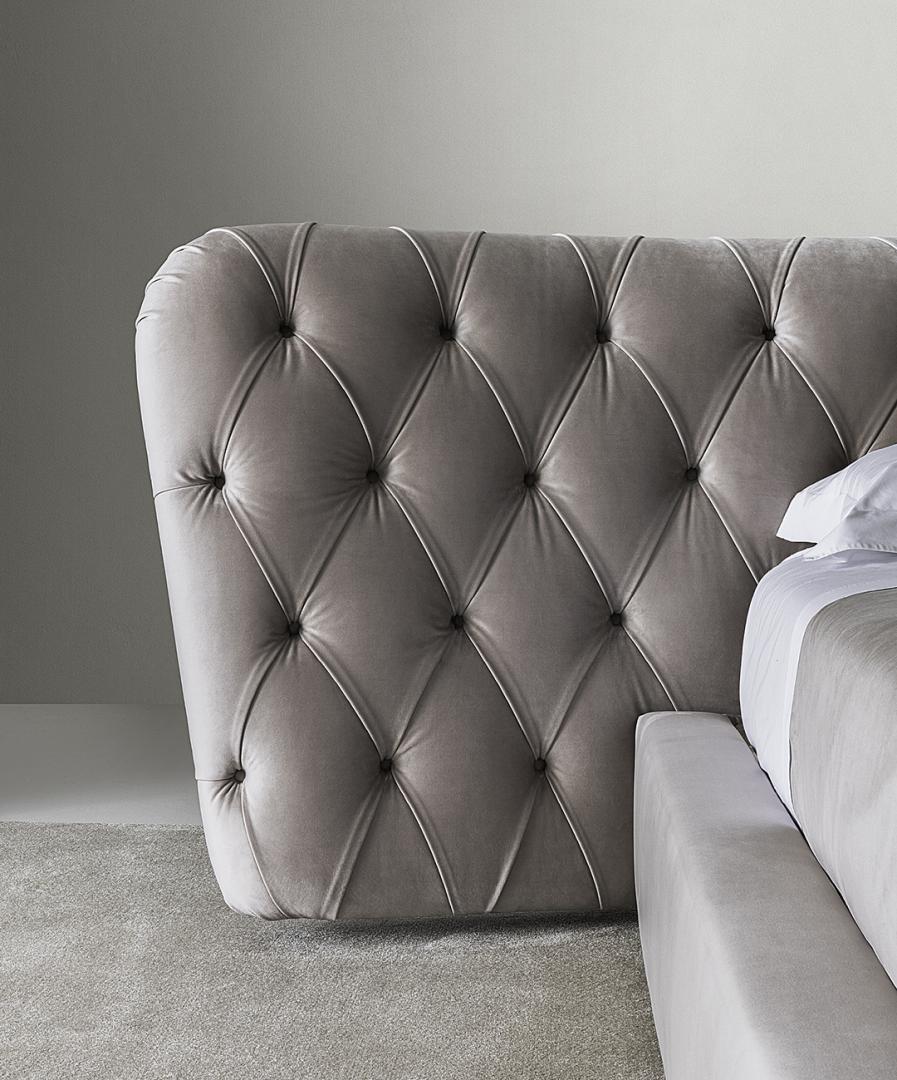 Close-up of the luxurious Casamilano Royale Capitonné bed's tufted headboard in neutral gray, a modern design element for elegant bedroom decor