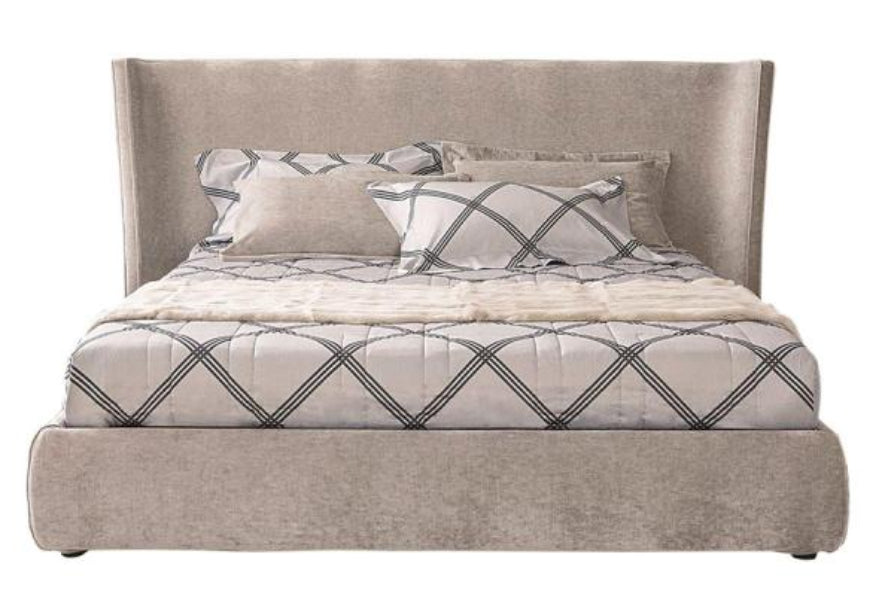 Front view of the Casamilano Vanity bed featuring a tall, upholstered headboard, decorative pillows, and patterned duvet cover