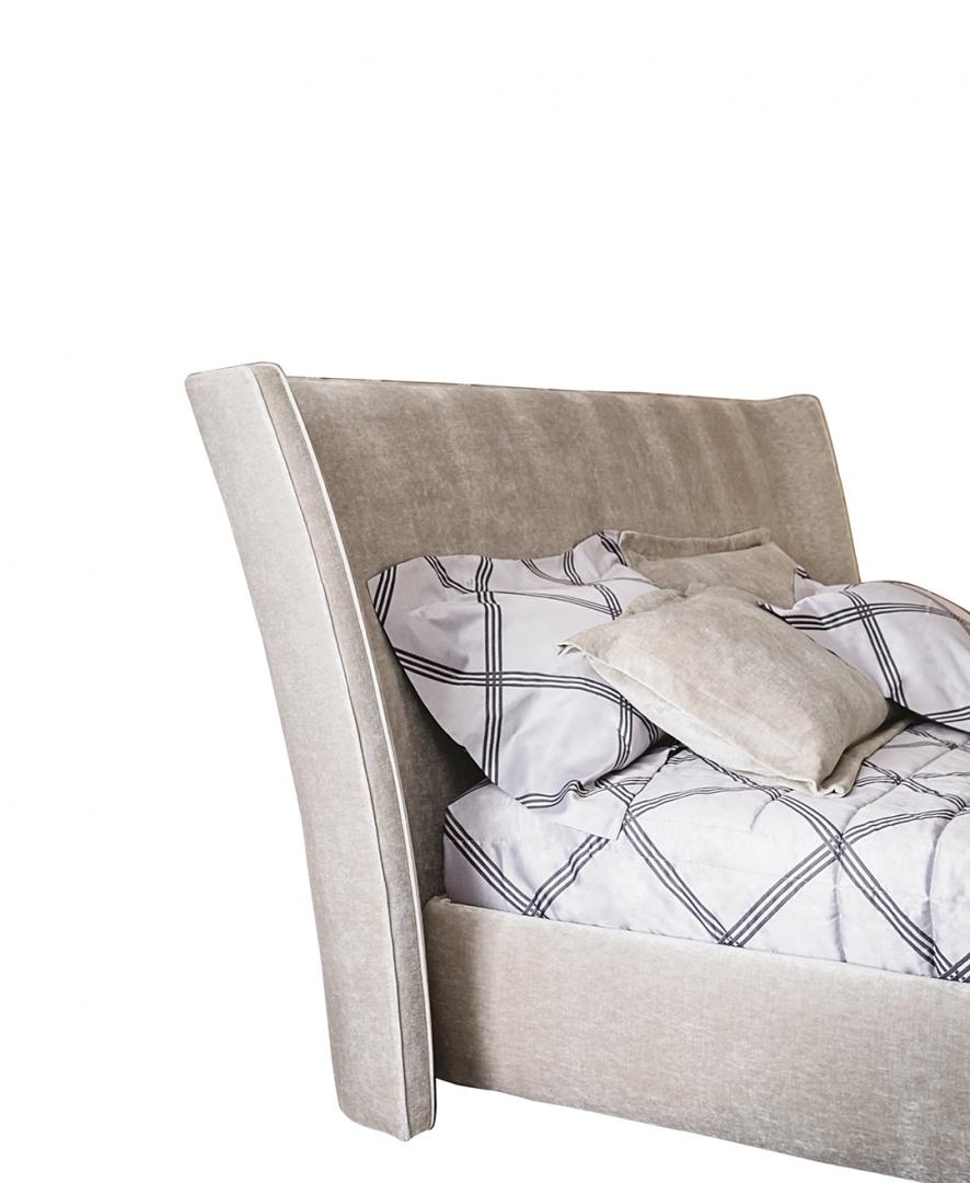 Close-up of the Casamilano Vanity bed featuring a tall, curved, upholstered headboard, perfect for modern bedroom designs
