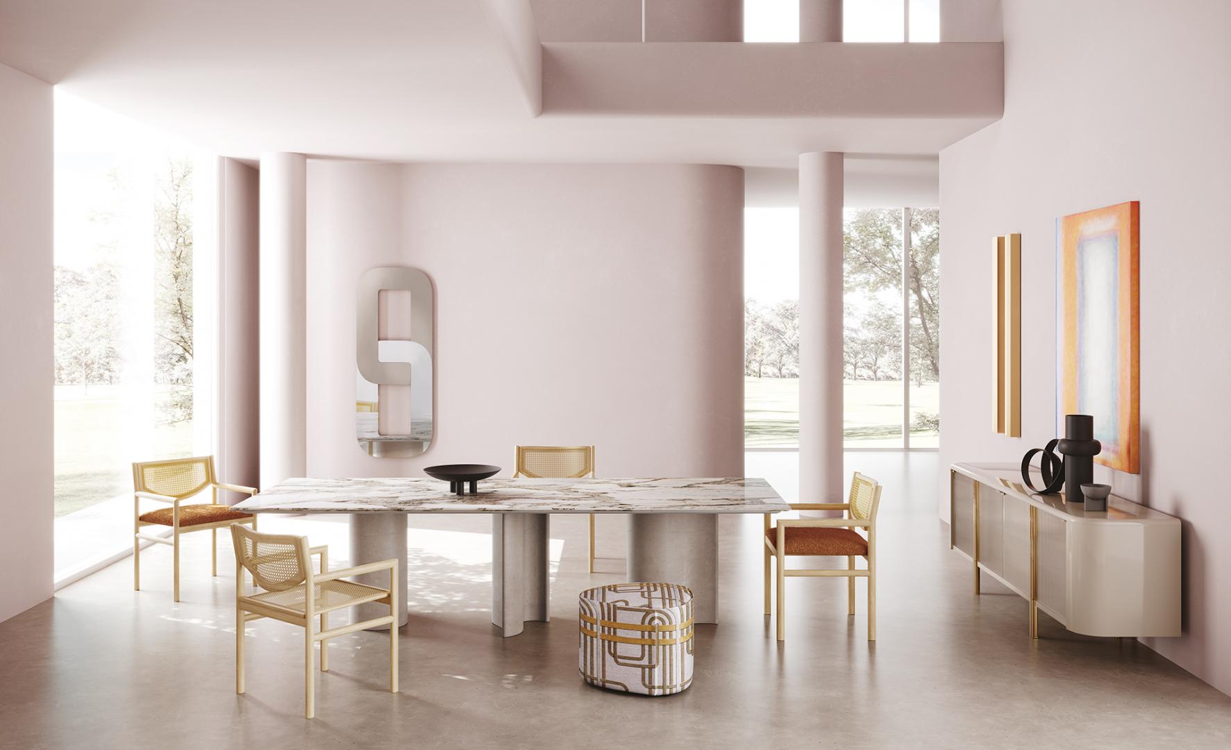 Modern dining room with marble table, cane chairs, and Casamilano Tecla sideboard, complemented by stylish decor and pink accents