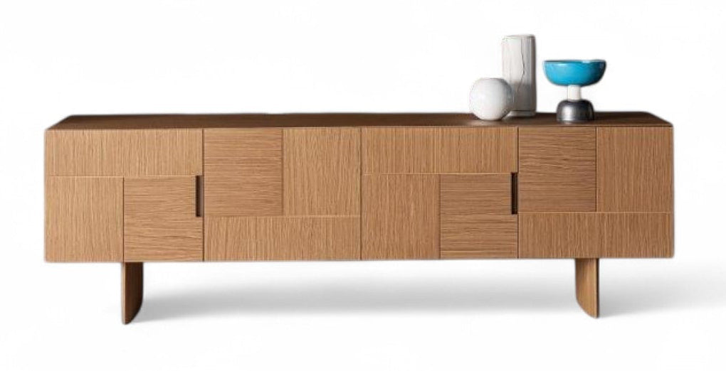 Studio shot of wood sideboard with decor on top.