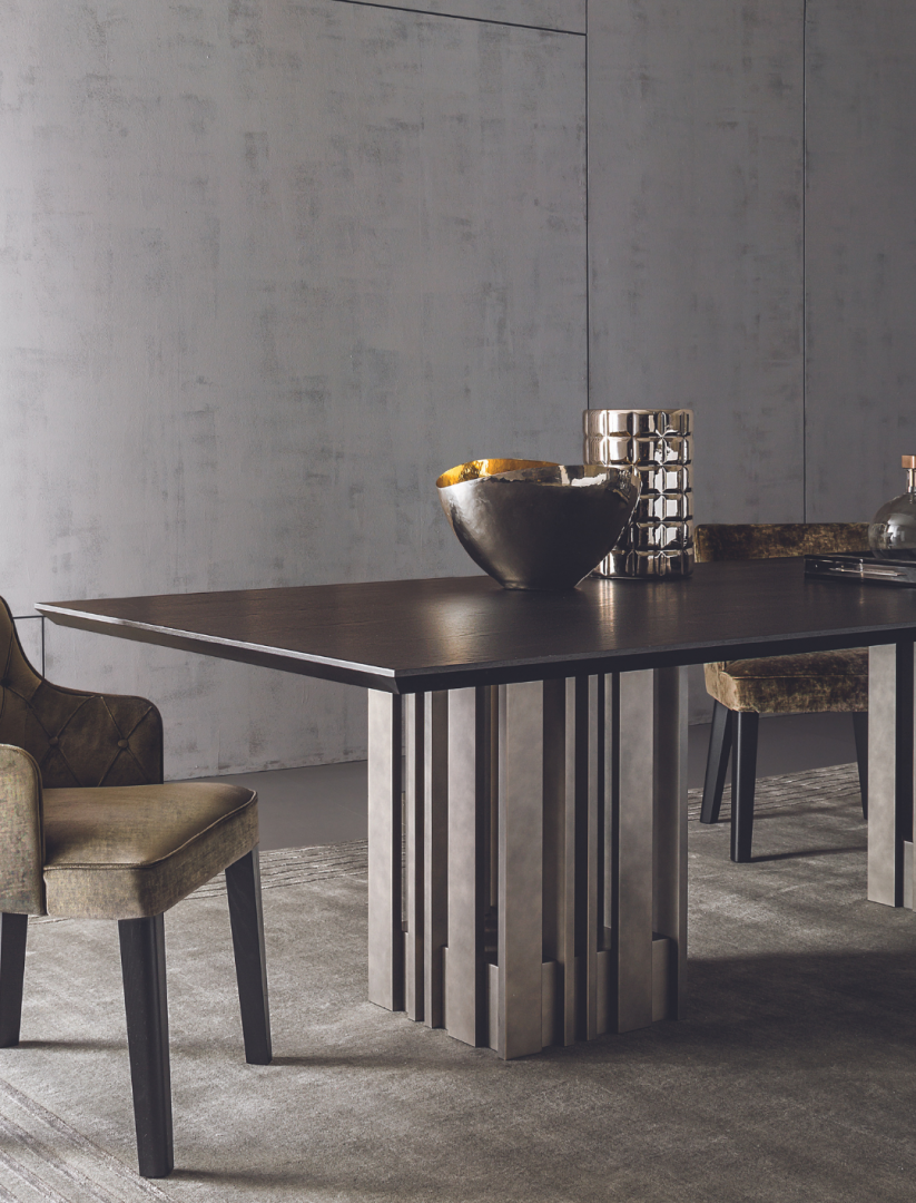 Modern dining room featuring the Casamilano Empire dining table with dark wood and metal base, upholstered chairs, and decorative accessories