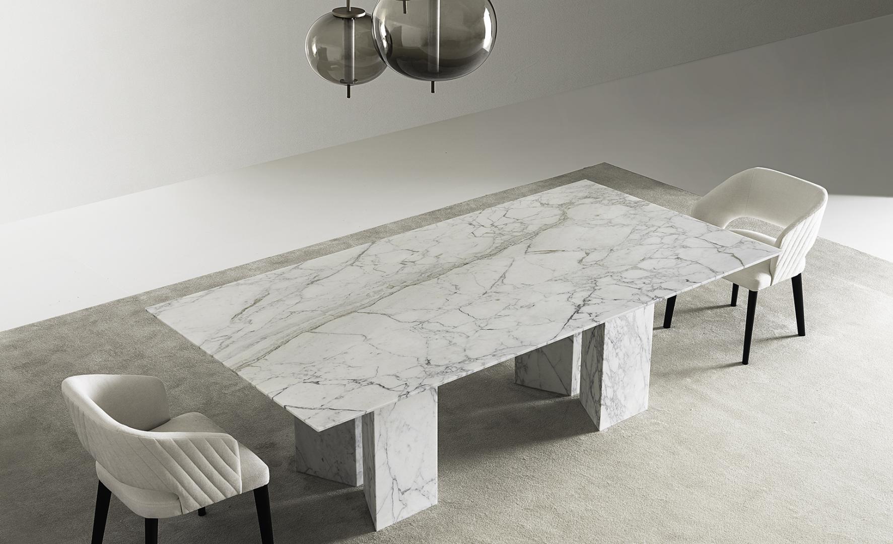 Modern dining room featuring a Casamilano Karl marble table and upholstered chairs, perfect for luxury interior design