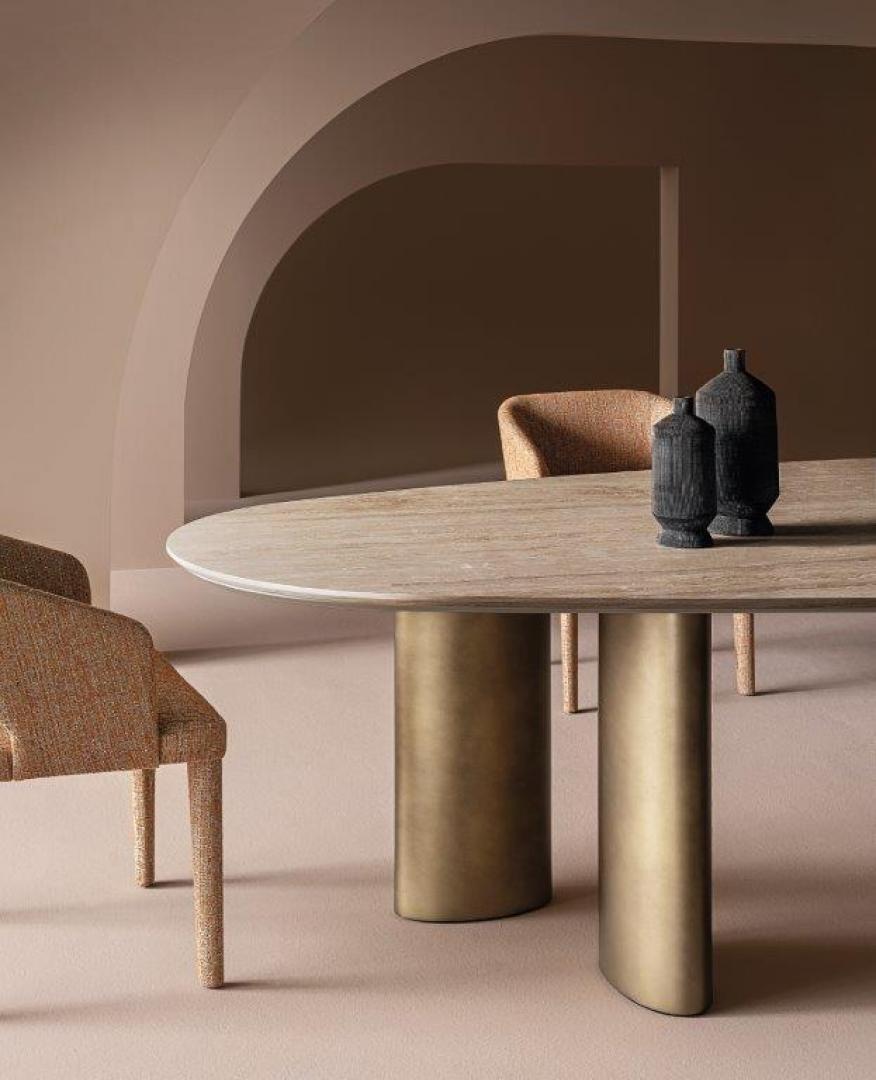 Interior with Casamilano Arne dining table, brushed gold base, upholstered chairs, decorative vases, modern furniture design