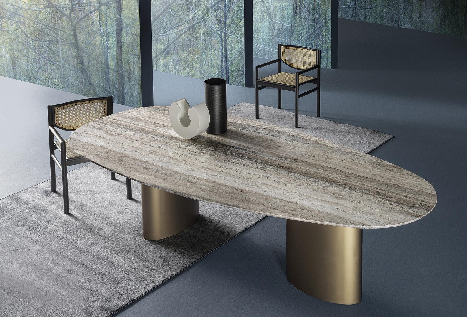 A modern dining room featuring the Casamilano Tangeri dining table with a stone top and metal base, complemented by stylish dining chairs and decor