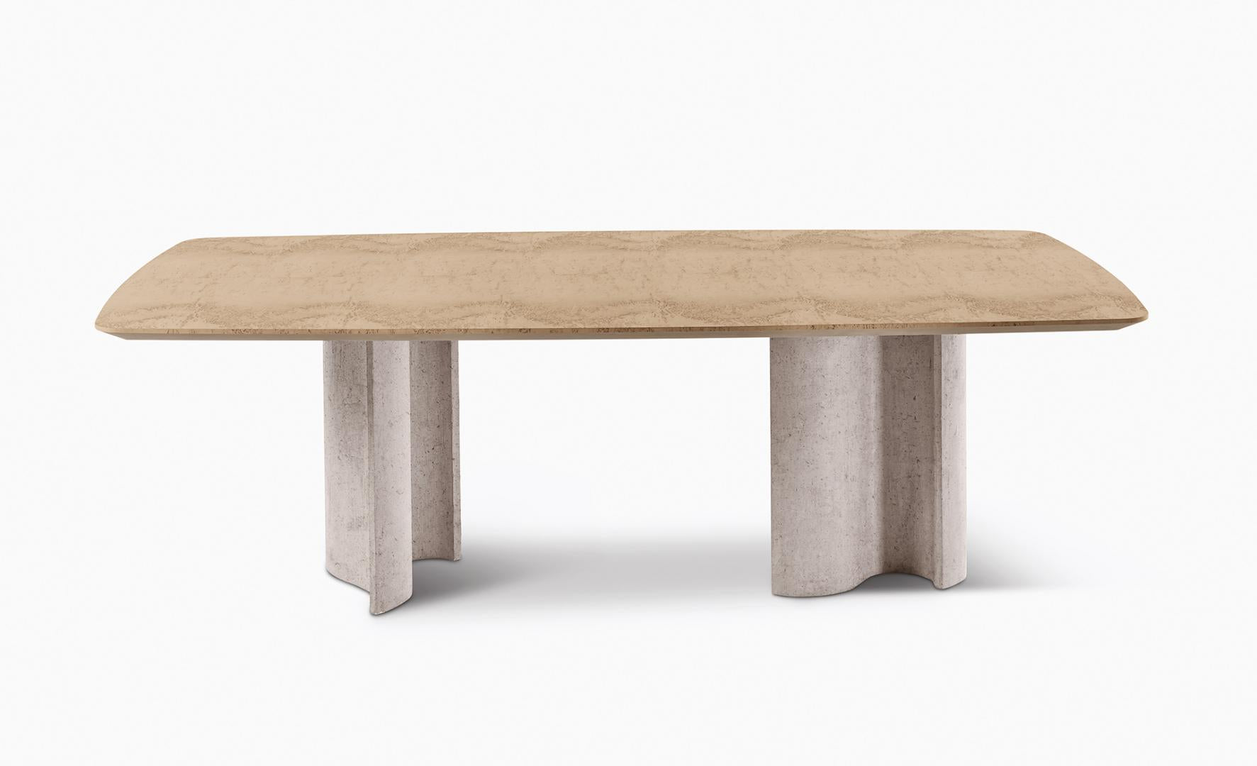 Modern travertine dining table by Casamilano. The Virgola IN & OUTDOOR table features stone pedestal legs, ideal for luxury minimalist interiors
