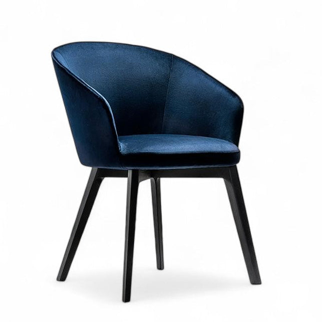 Blue velvet upholstered chair with black wooden legs