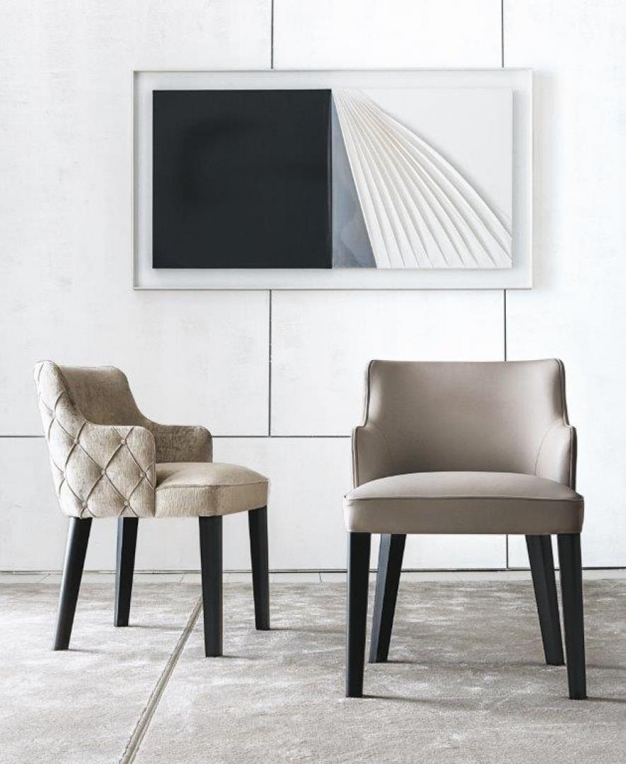 Interior with Casamilano Royale Capitonné dining chairs: diamond-tufted & streamlined designs, neutral upholstery, black legs, modern art