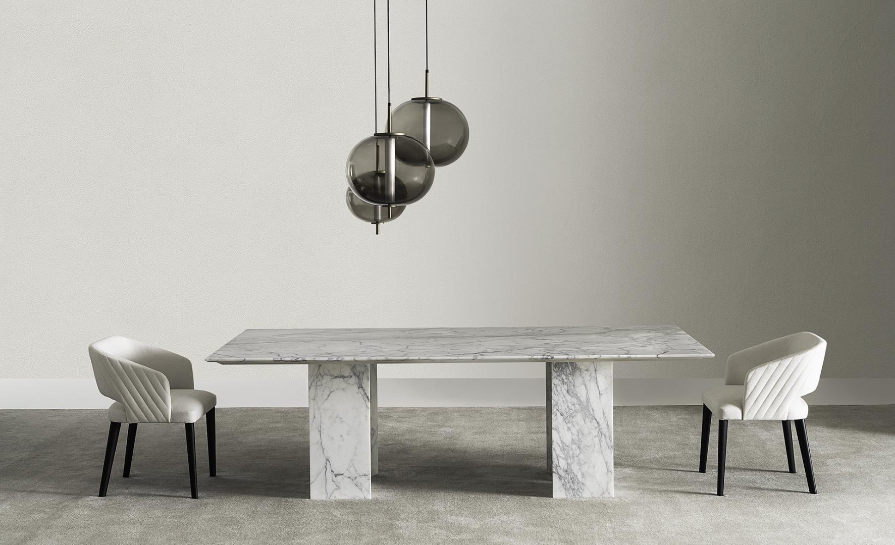 Modern dining room featuring a marble table, pendant lights, and Casamilano Elsa Quilt upholstered dining chairs with black legs