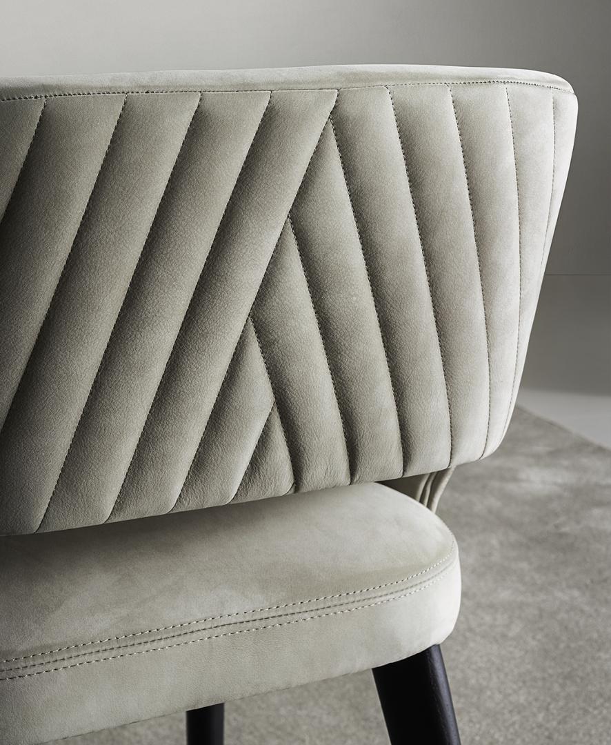 Close-up of the Elsa Quilt dining chair by Casamilano. Features quilted velvet upholstery, showcasing modern furniture design and luxury