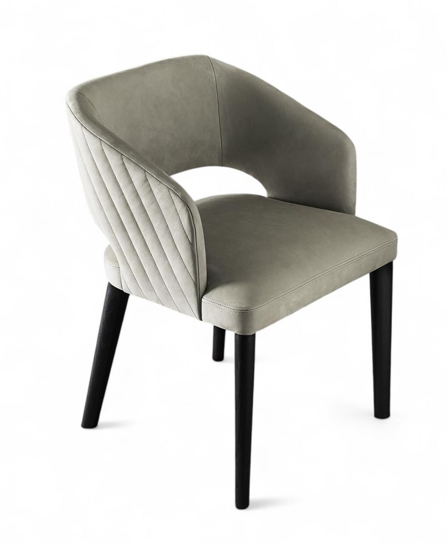 Gray upholstered dining chair with quilted back and black legs