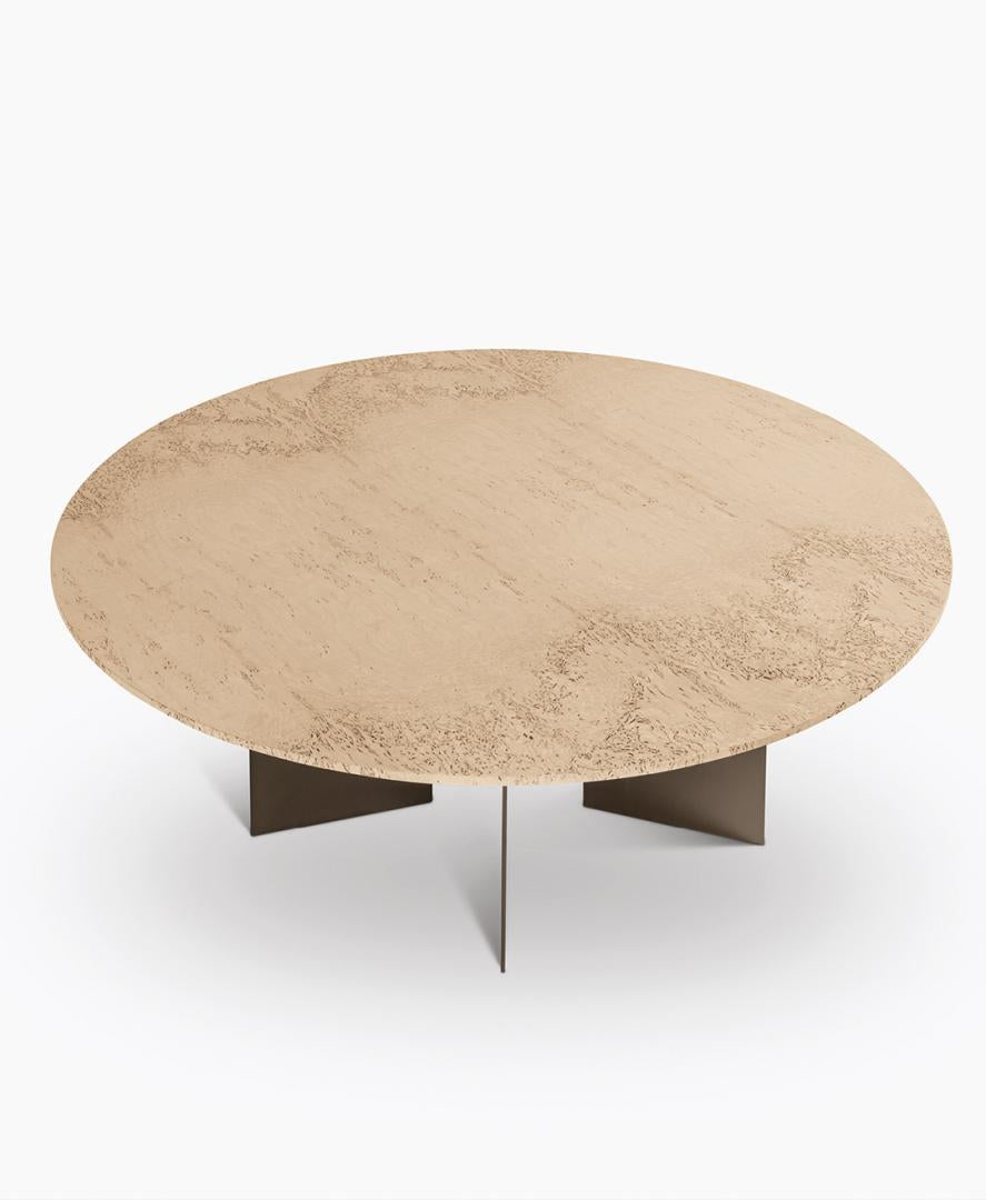 Round modern coffee table with textured beige top and metal base.