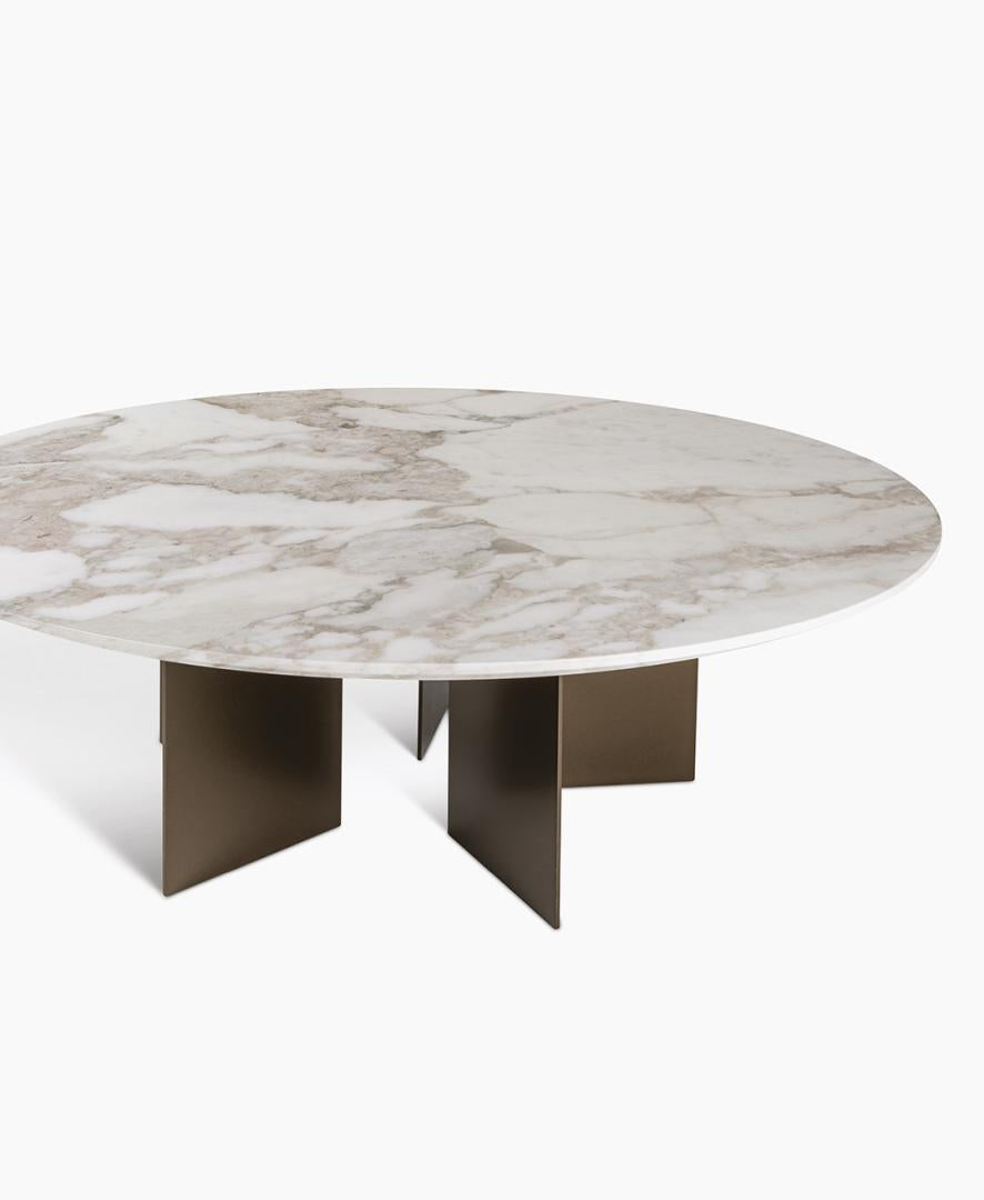 Eye-level studio shot of the Casamilano Vito coffee table. Features a round marble top, bronze metal base, and modern design. Perfect luxury furniture