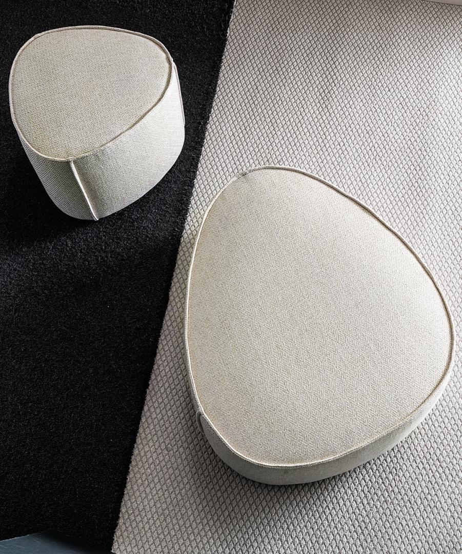 Overhead view of Casamilano Francis ottomans in neutral fabric on a black and grey textured rug. Modern seating for contemporary living spaces.