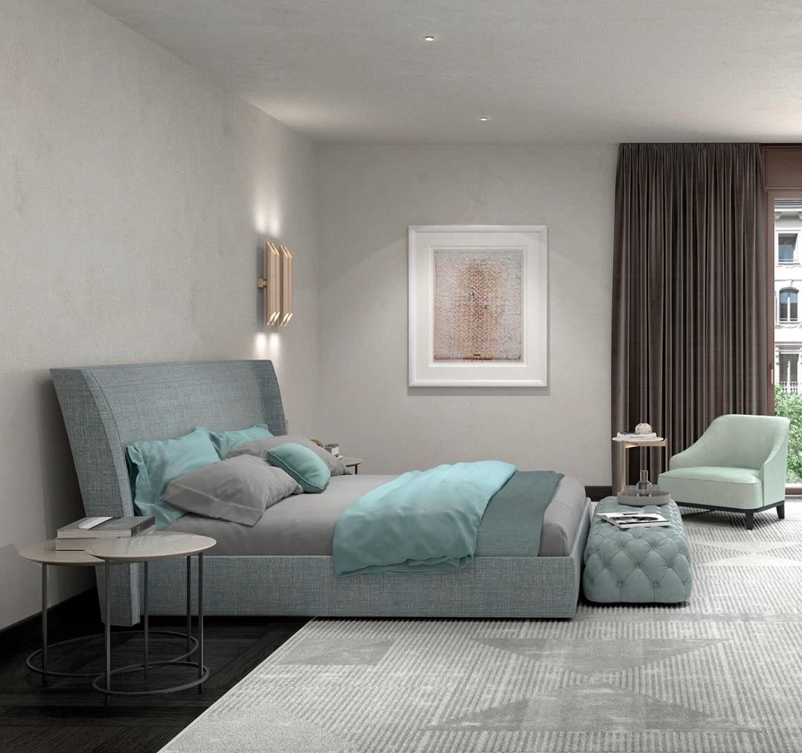 Modern bedroom featuring a light blue upholstered bed, ottoman, side chair, wooden vanity, and area rug. Casamilano Hyatt 160 Pouf is included
