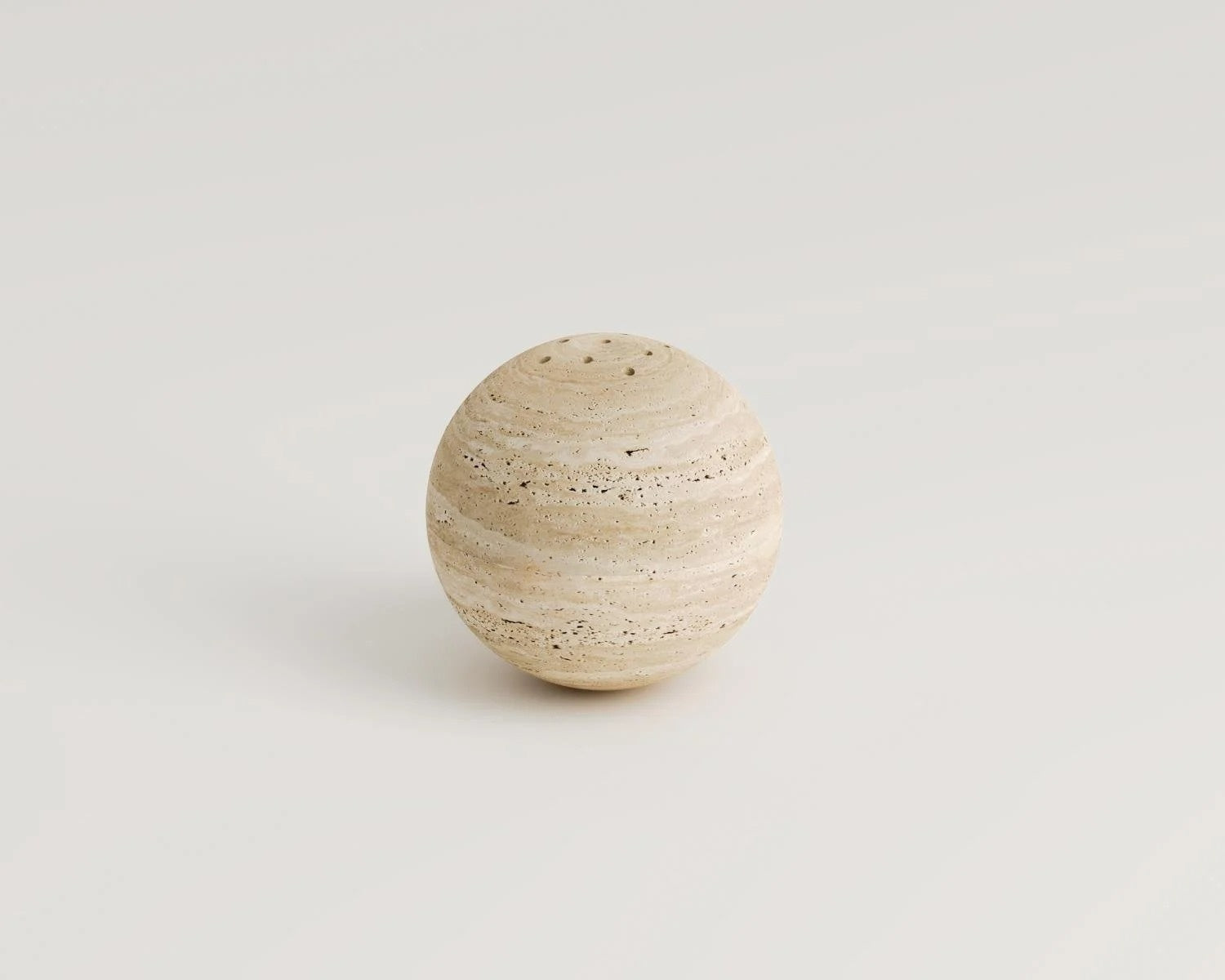 Travertine stone spherical salt shaker with holes on top