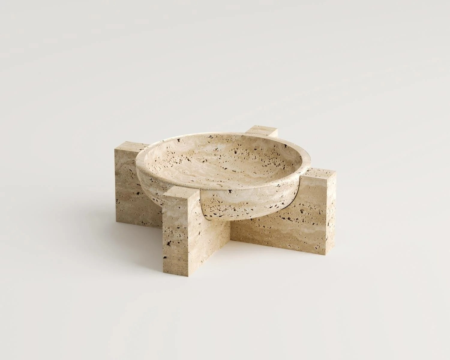 Studio shot of beige travertine bowl decor on block base.