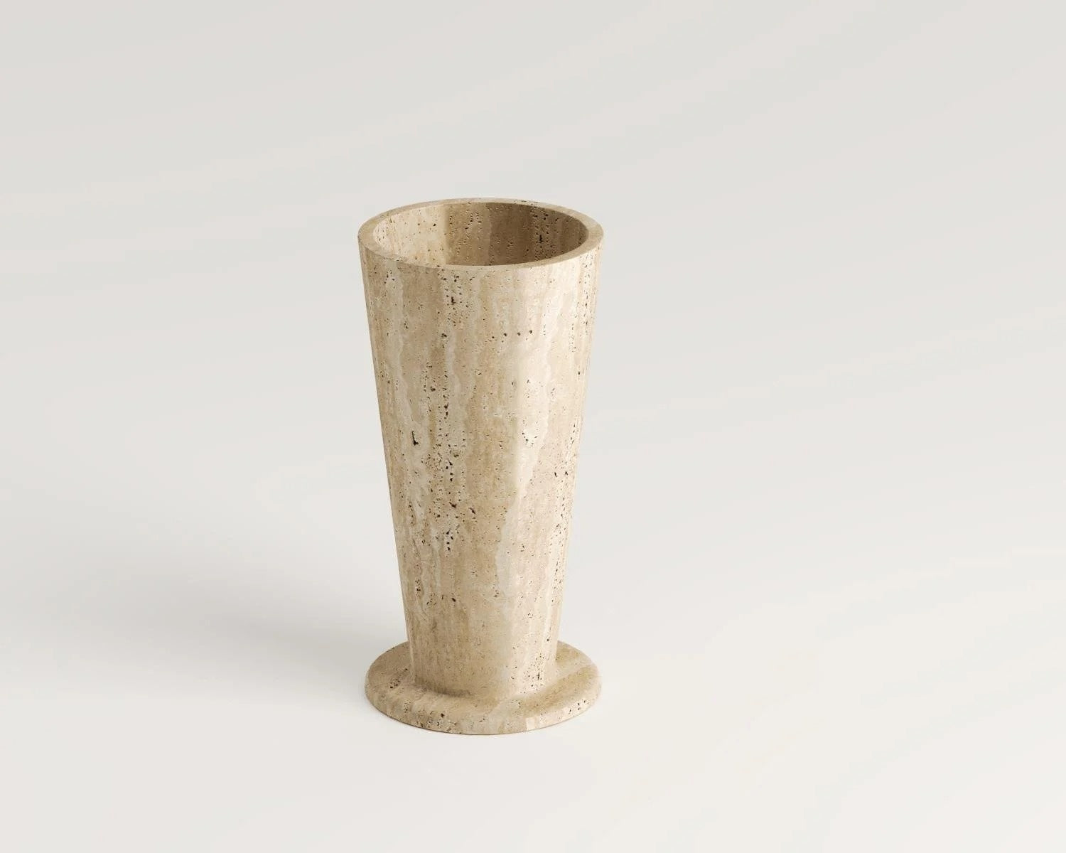 Travertine stone vase with flared shape on white background decor