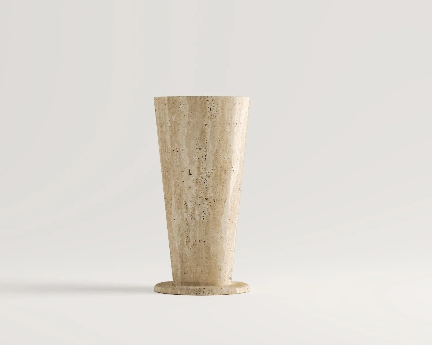 Travertine vase with tapered shape on a white background