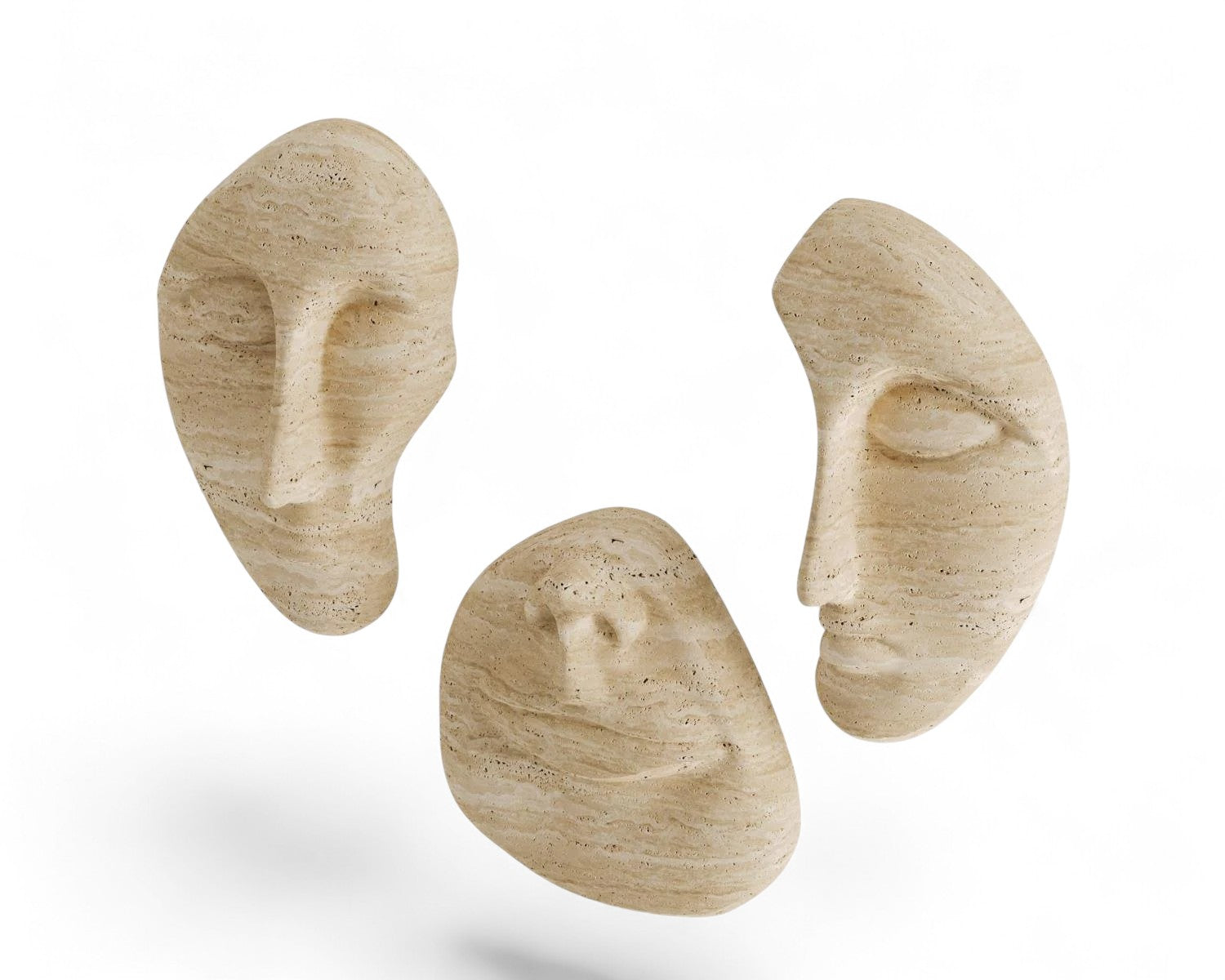 Three beige travertine face sculptures floating on white background