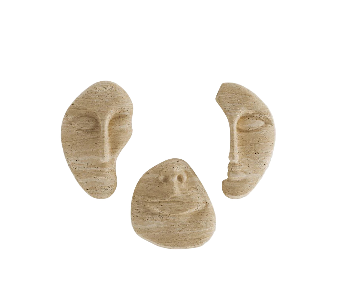 View of three travertine face sculptures against white background.