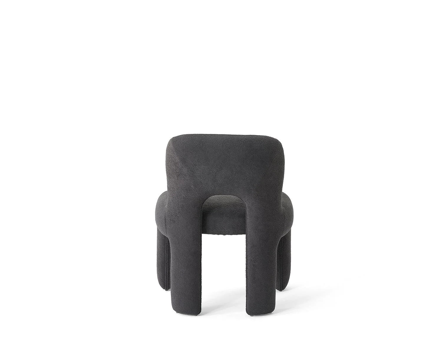 Rear view dark gray upholstered chair on white background
