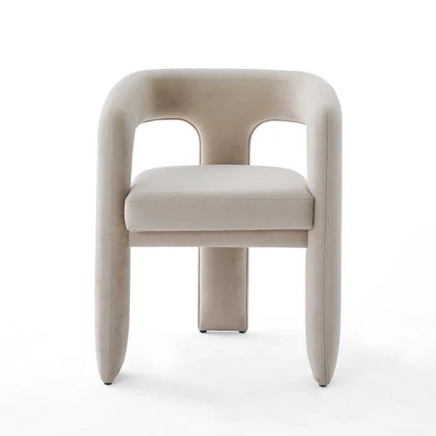 View of beige upholstered dining chair with curved back and legs. modern furniture, dining room chair, upholstered seating, contemporary design, neutral color chair, accent chair, curved back chair, interior design.