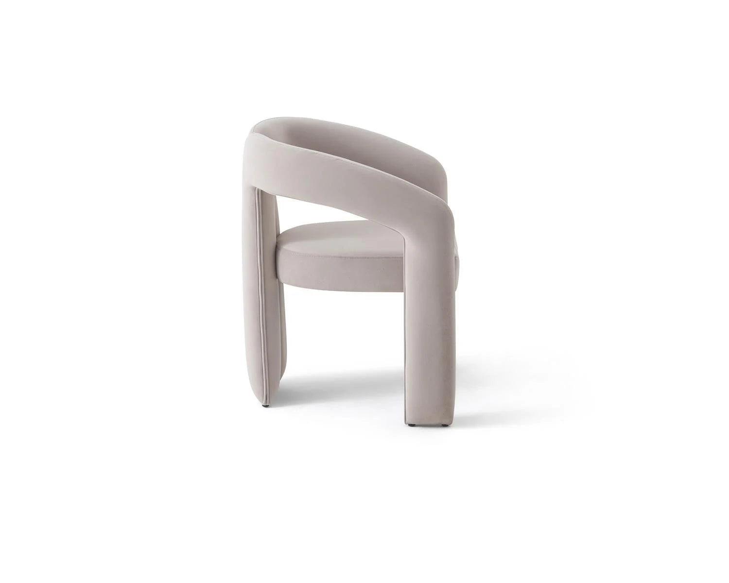Studio shot of a light gray upholstered chair with curved arms