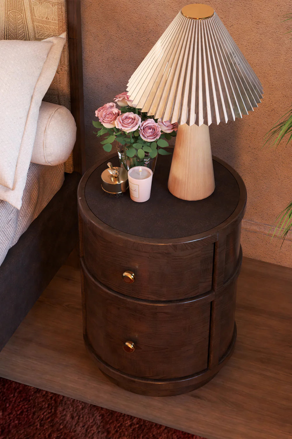 Bedroom scene with dark wood nightstand, lamp, flowers, and bed furniture.
Dark wood nightstand with two drawers, gold knobs, and round shape.
Pleated wood shade table lamp on dark wood nightstand next to bed.
Close up of dark wood nightstand with lamp and pink roses.
Round dark wood nightstand with two drawers and gold hardware.
Bedroom furniture including dark wood nightstand and pleated shade lamp.
Dark wood nightstand holding lamp, vase of roses, and small candle.