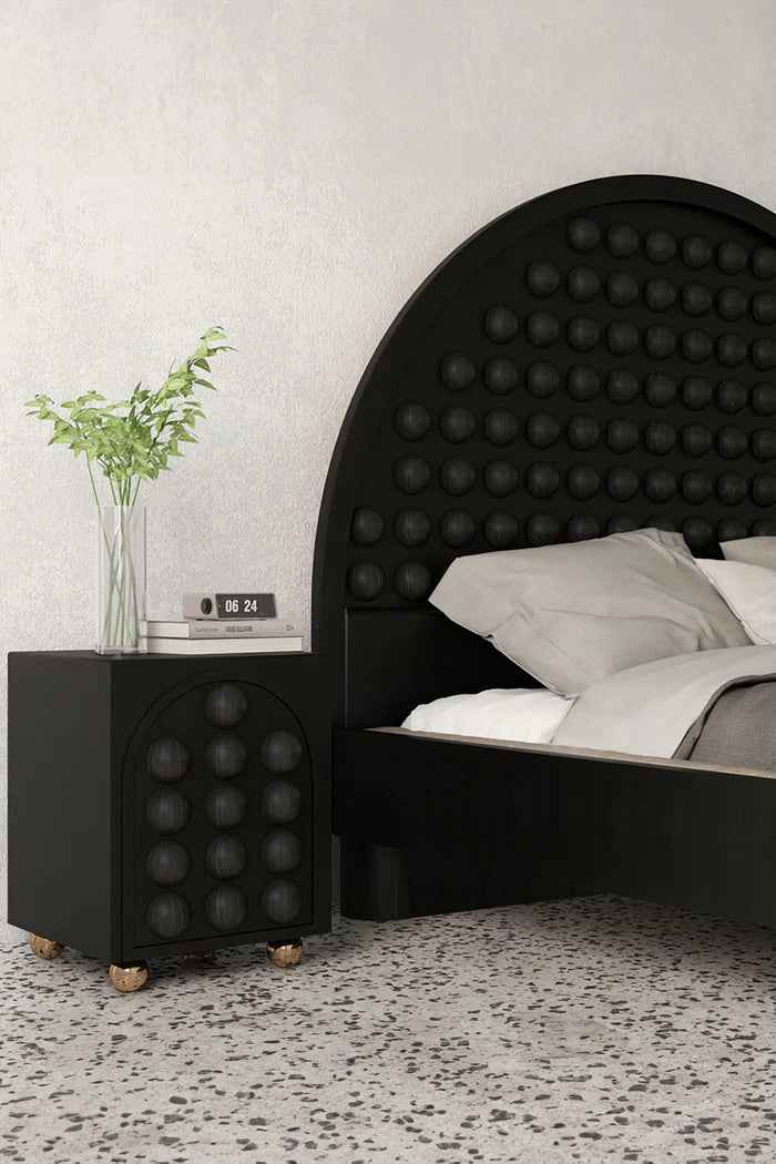 Bedroom interior with black wood bed and nightstand with round details