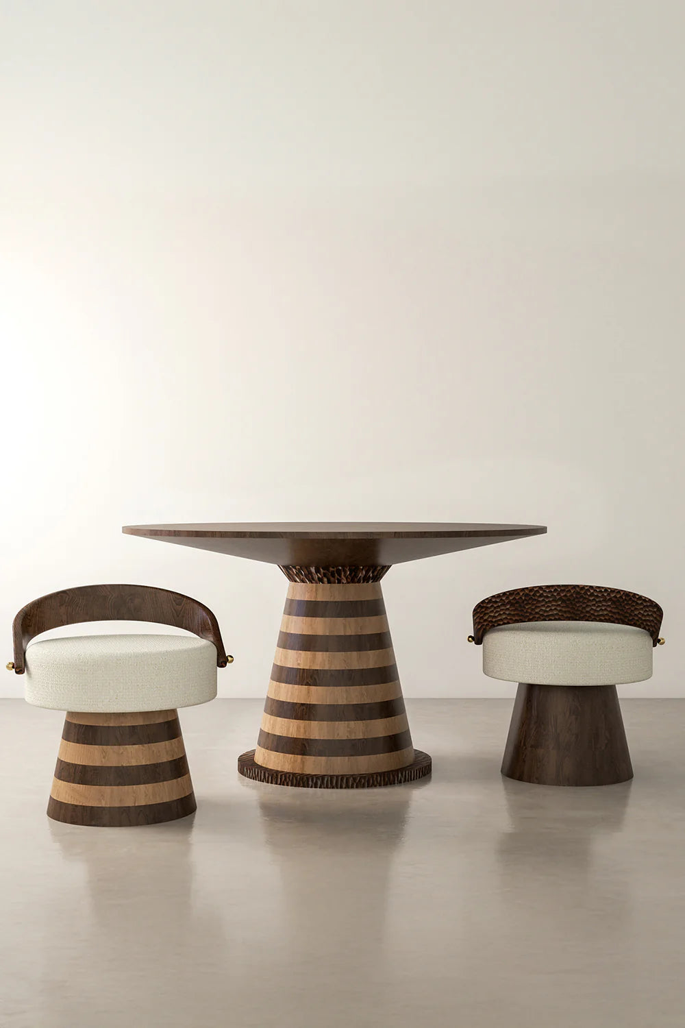 View of wooden pedestal table and two upholstered chairs in a room.