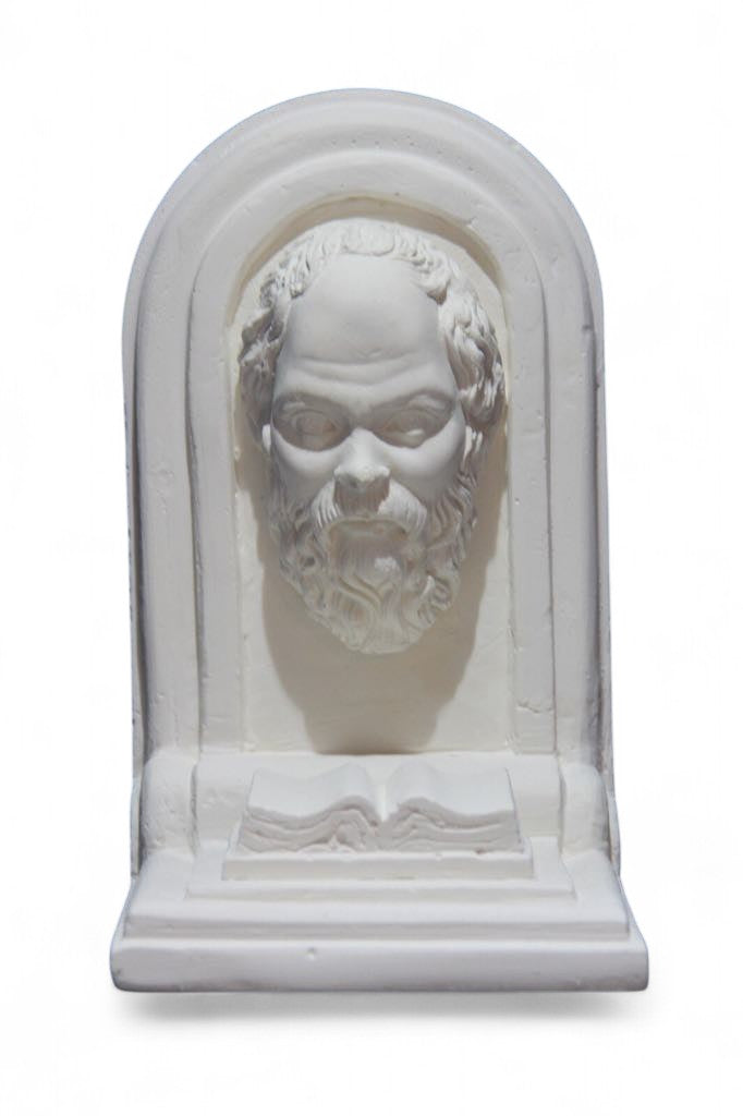 White plaster sculpture with bearded face and open book base