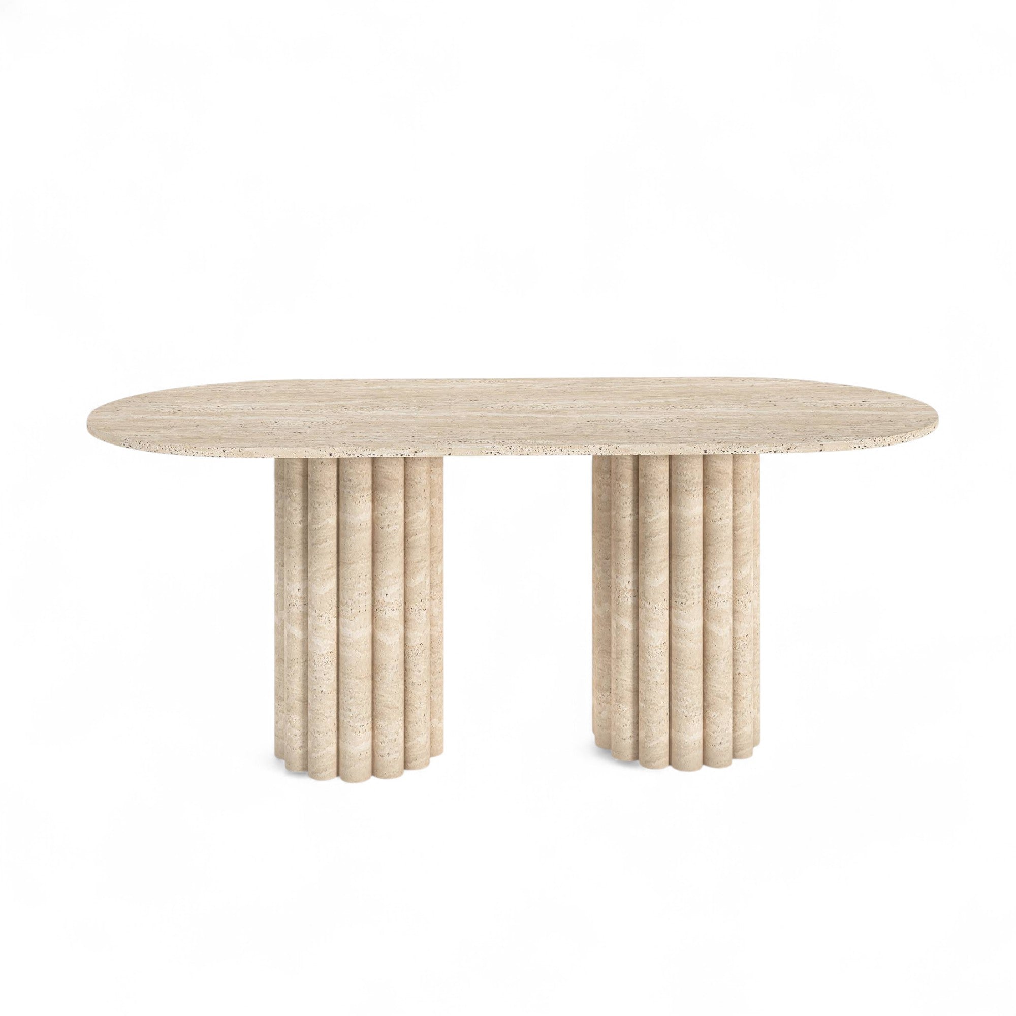 Studio shot of travertine dining table with fluted cylindrical bases on white background. Travertine dining table, fluted base, natural stone furniture, modern dining room, luxury home decor, neutral color palette.