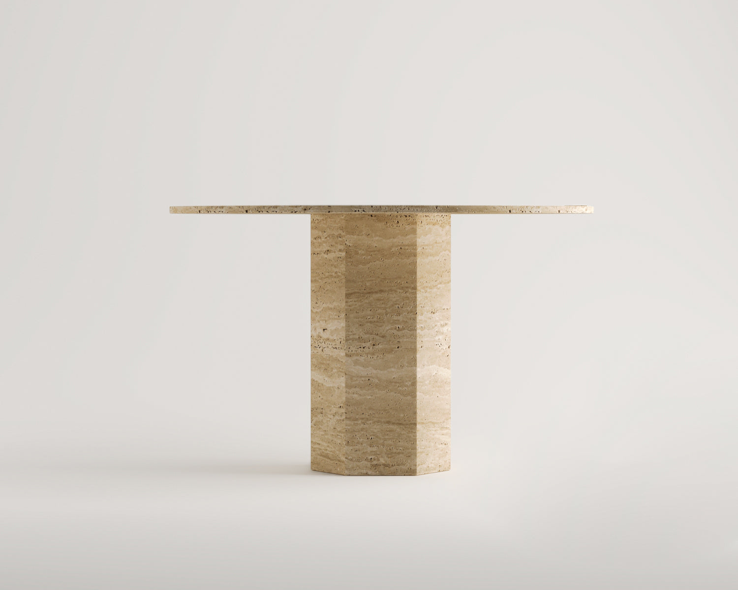 Luzione Elpis travertine side table with hexagonal base and round top. Modern accent furniture for living room or bedroom.