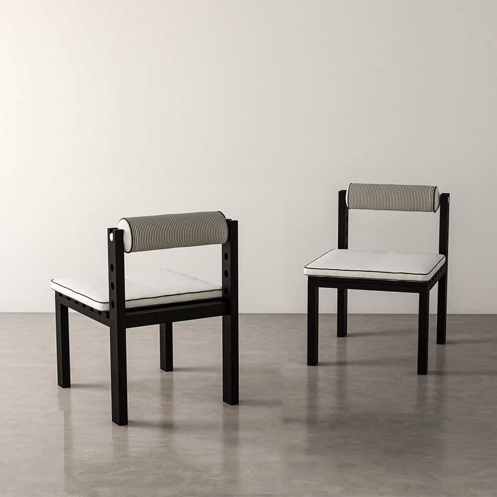 Two black chairs with white and striped cushions furniture