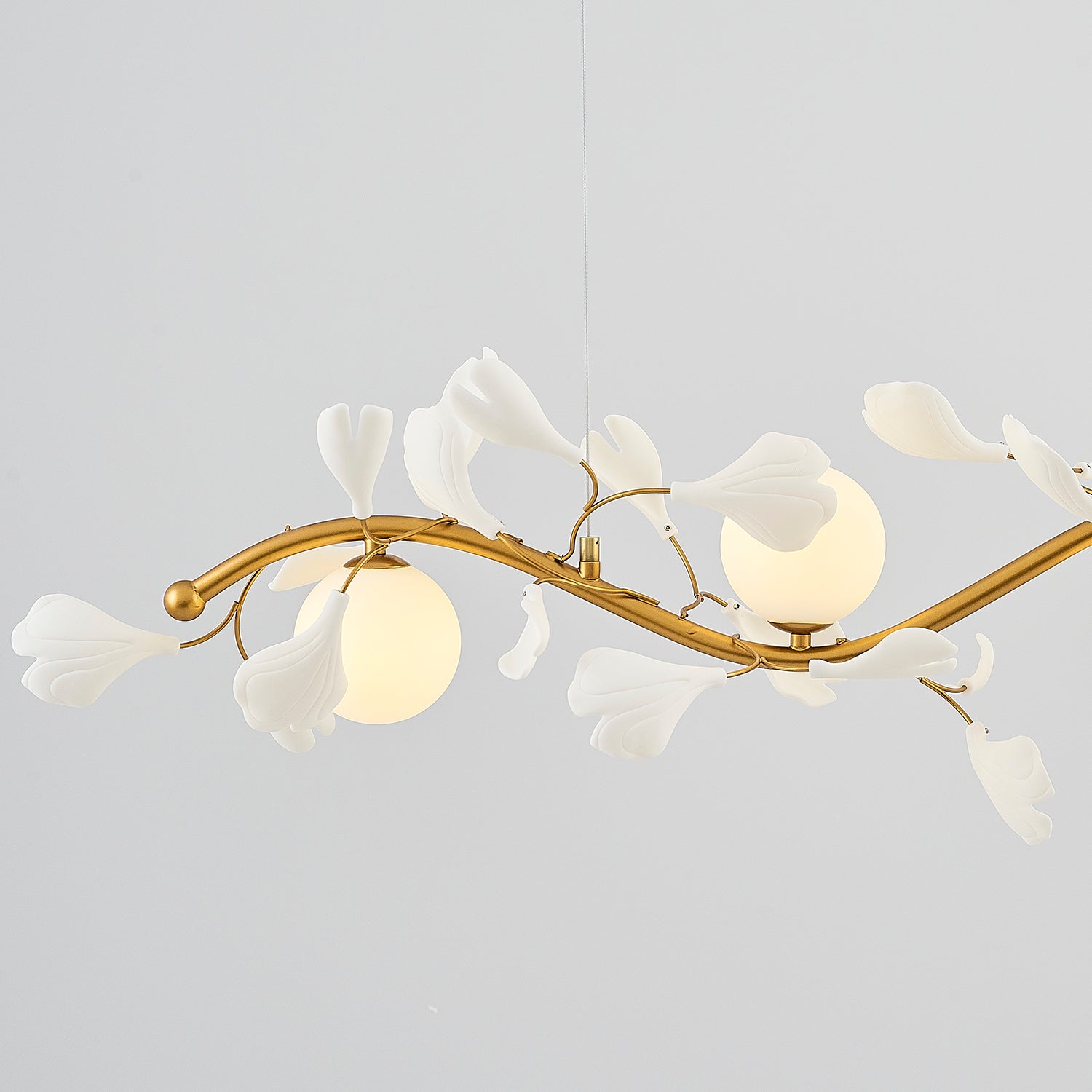 Close up view of gold branch lighting with white flower accents
