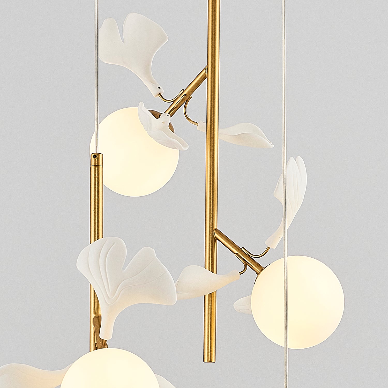 Gold pendant lighting with white ginkgo leaf decor globes