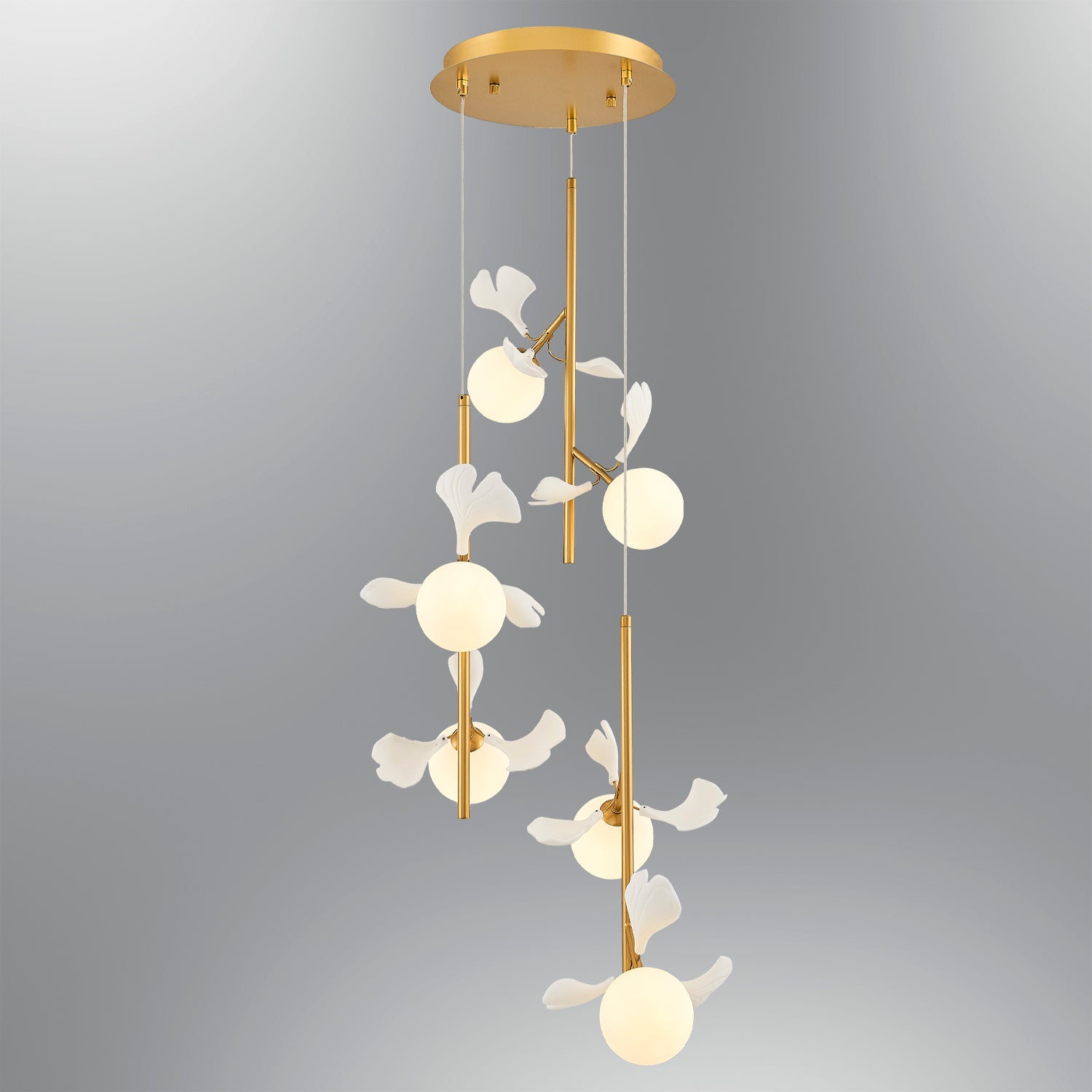 Gold metal chandelier with white globe lights and leaf accents