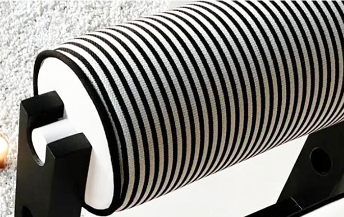 Close-up of the backrest of the black and white striped outdoor armchair fabric with a textured surface.